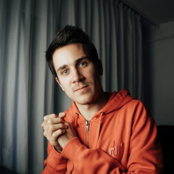 Avery Lin, Lead Design Curator at Solario Nexus, reviewing corporate floral arrangements